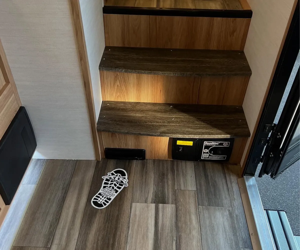 A VacPort sweep inlet built into the base of a staircase